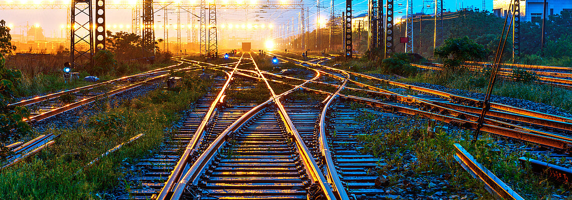 Railway tracks with lights in the distance